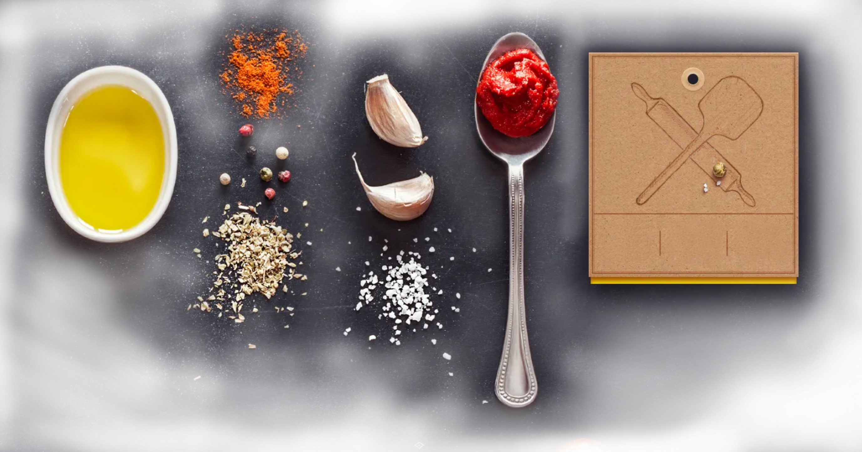 Olive oil, garlic, herbs, salt and tomato paste beside a vintage pizza-tools tag